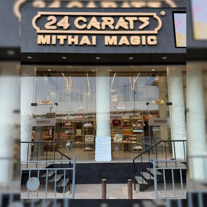 Storefront of a 24 Carats Mithai Magic sweet shop in Surat, India