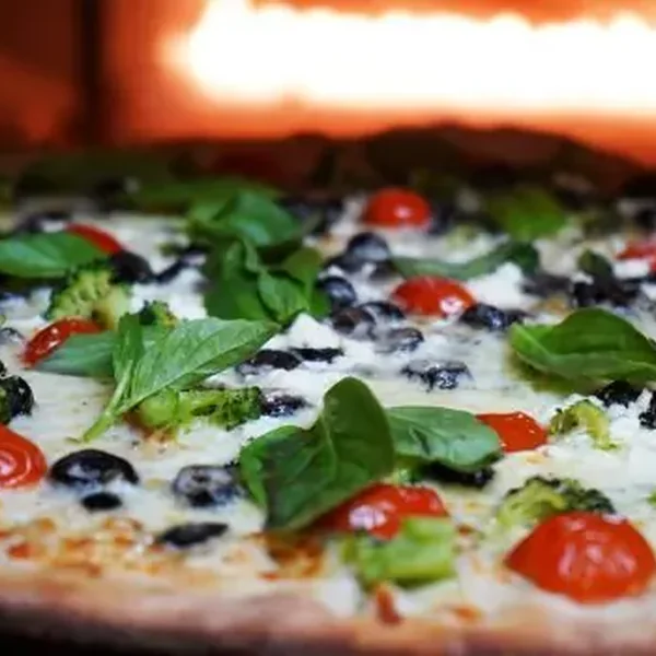 Vegan pizza with basil and cherry tomatoes at Bella Casa Vegana, USA, a FoodChow online ordering customer