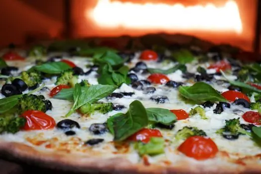 Vegan pizza with basil, broccoli, olives and cherry tomatoes at Bella Casa Vegana, New Haven