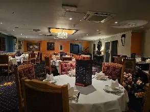 Dining room at Dil Raj Indian restaurant, Abingdon, with tables set for service
