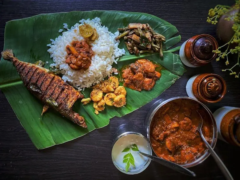 Kerala meal on a banana leaf with fish fry and curries, Rahaf Restaurant